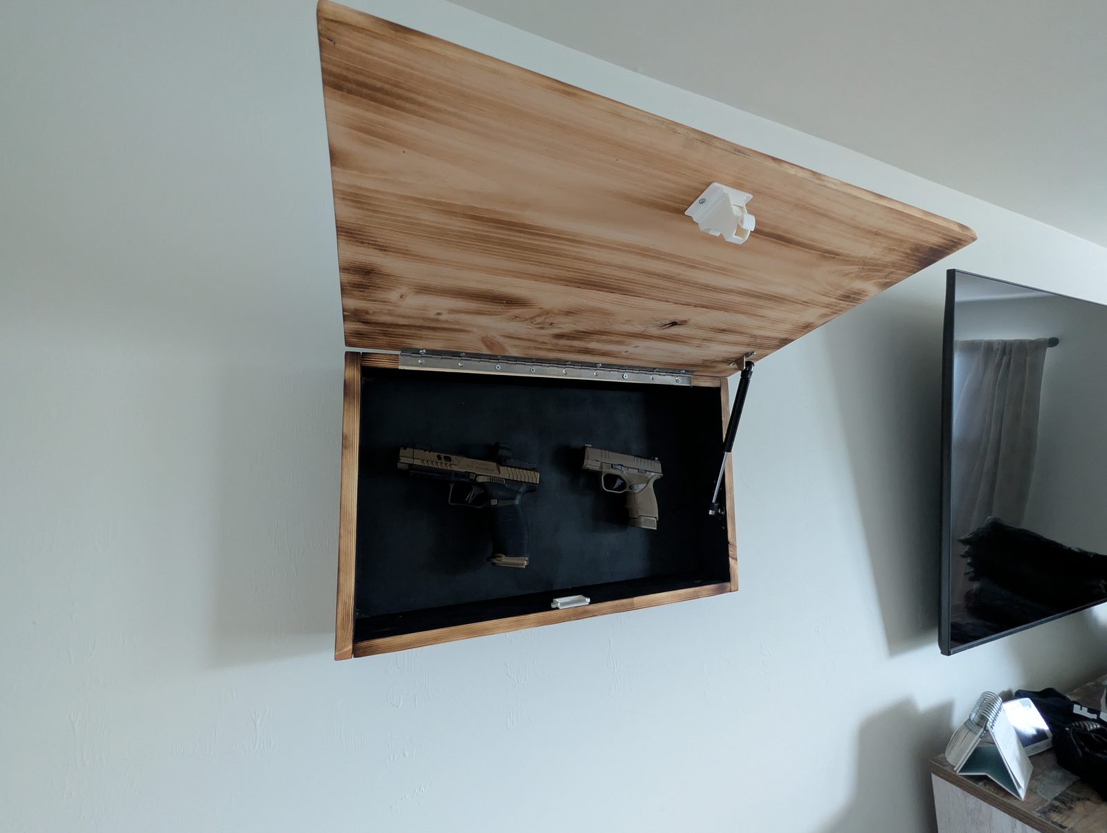 Cabinet in place — reads as a wall piece, opens to reveal storage