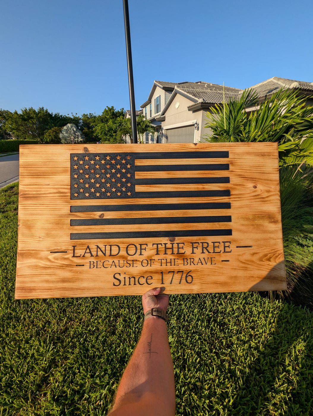 Land of the Free carved flag sign